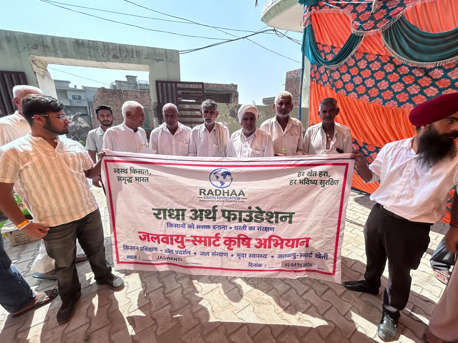 Farmers and facilitators holding the climate-smart agriculture campaign banner
